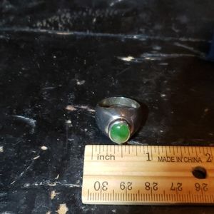 Silver tone ring band with green stone